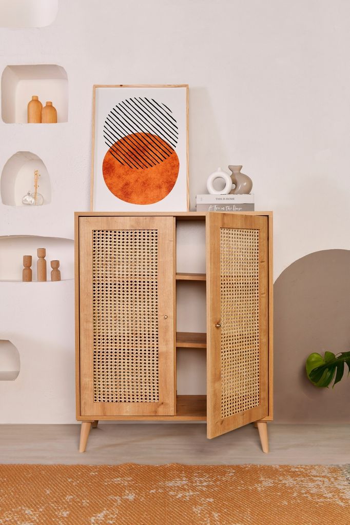 A wooden sideboard with rattan doors is displayed in a room with decorative elements on the wall.