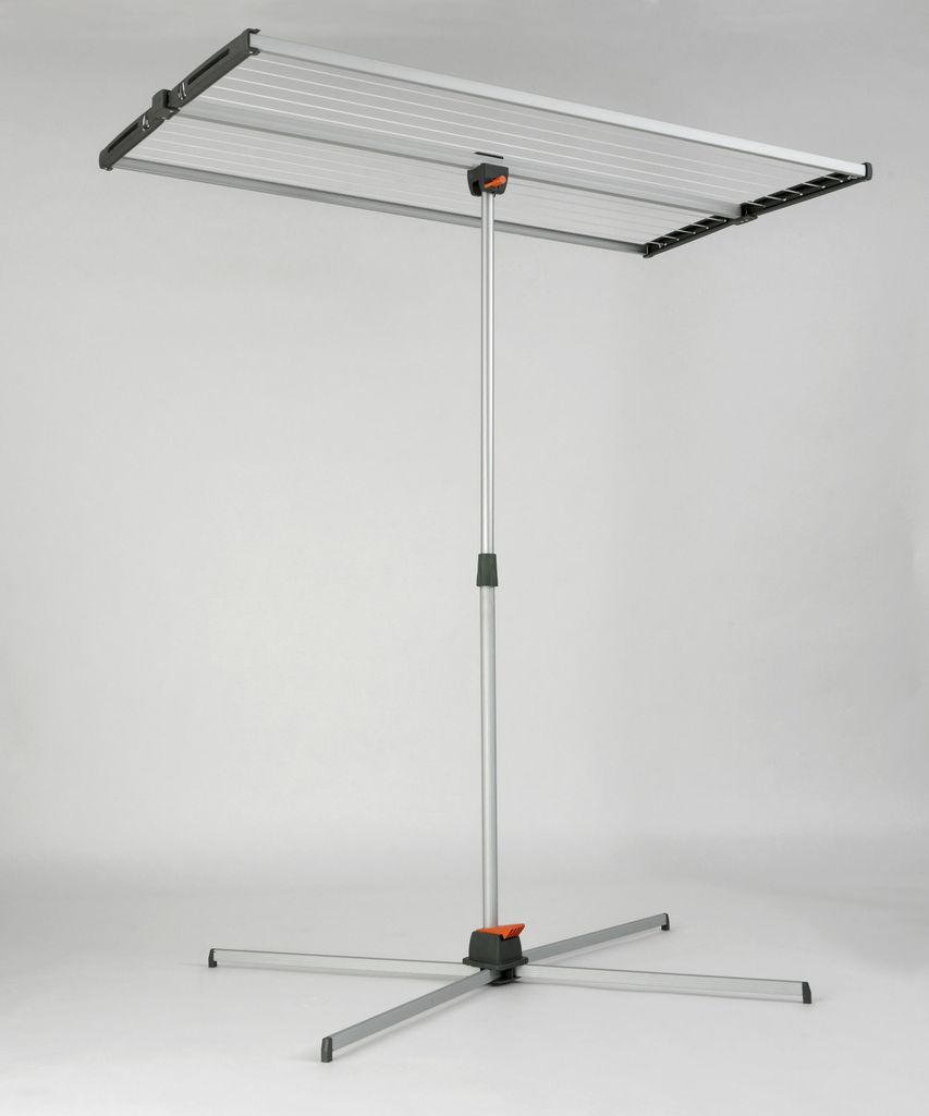 A freestanding clothes drying rack with a silver frame and black and orange accents, set against a plain light gray background.