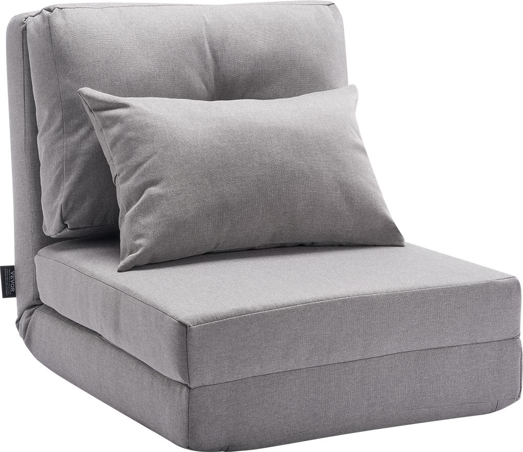 A gray convertible floor sofa with a pillow, shown in its upright chair configuration.
