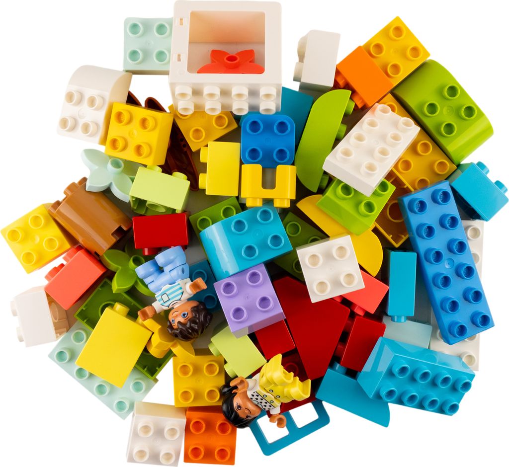 A pile of colorful LEGO DUPLO bricks and two small figures.