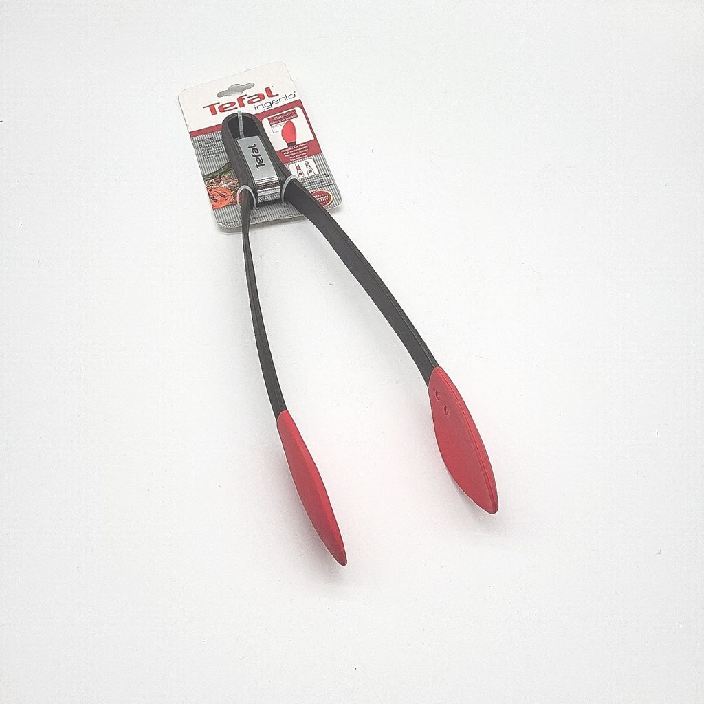 A pair of Tefal kitchen tongs in its original packaging, displayed against a white background.