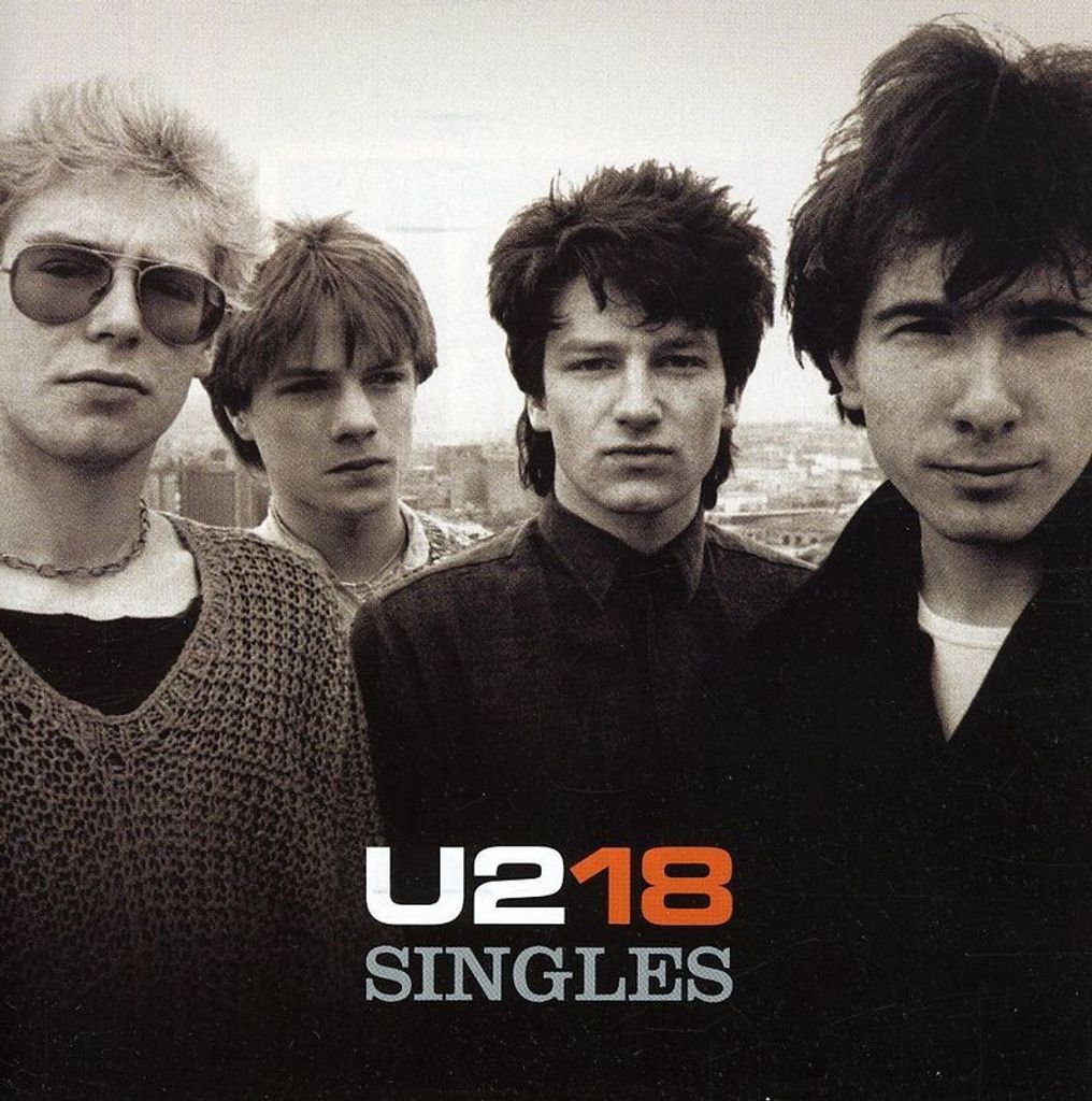 A black and white photo of the band U2, with text overlay.