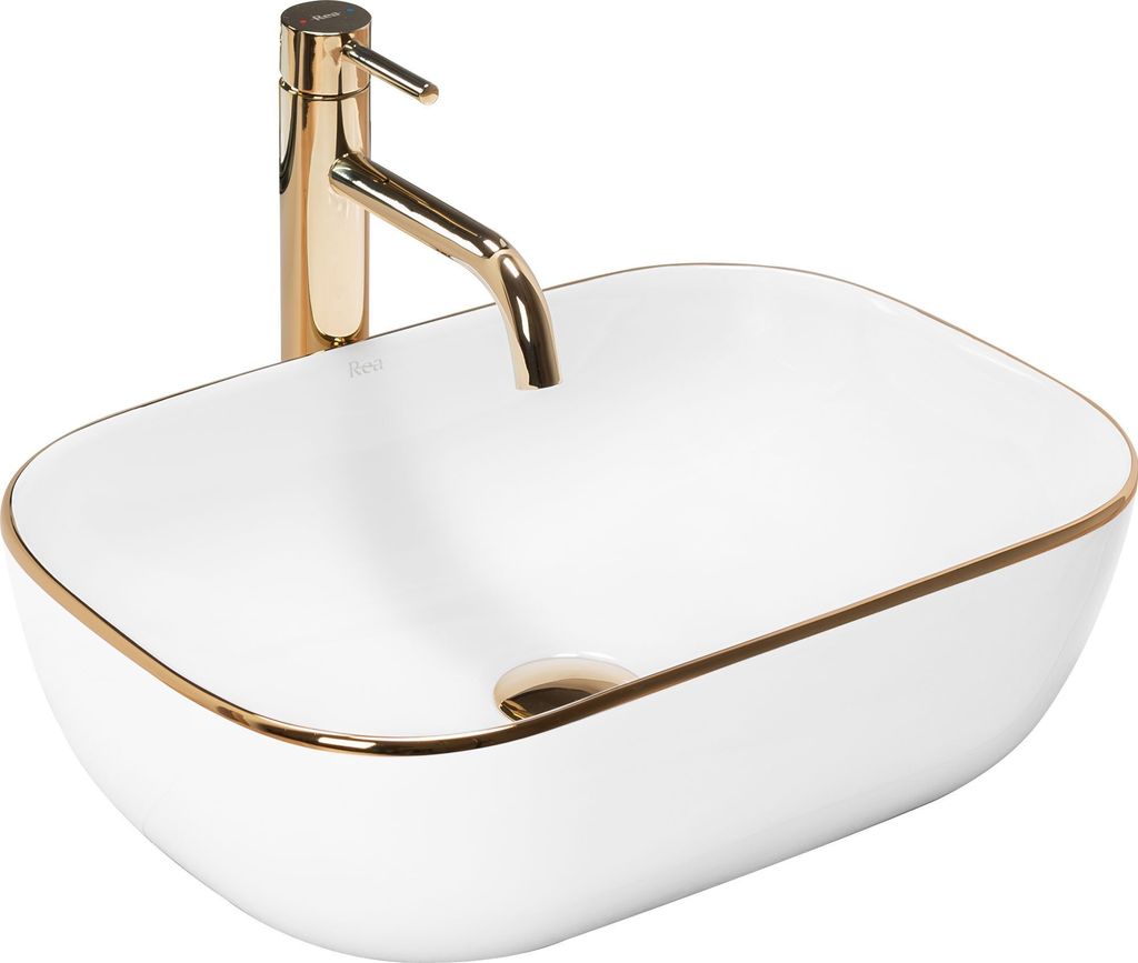 A white oval basin with a gold rim and a gold faucet.
