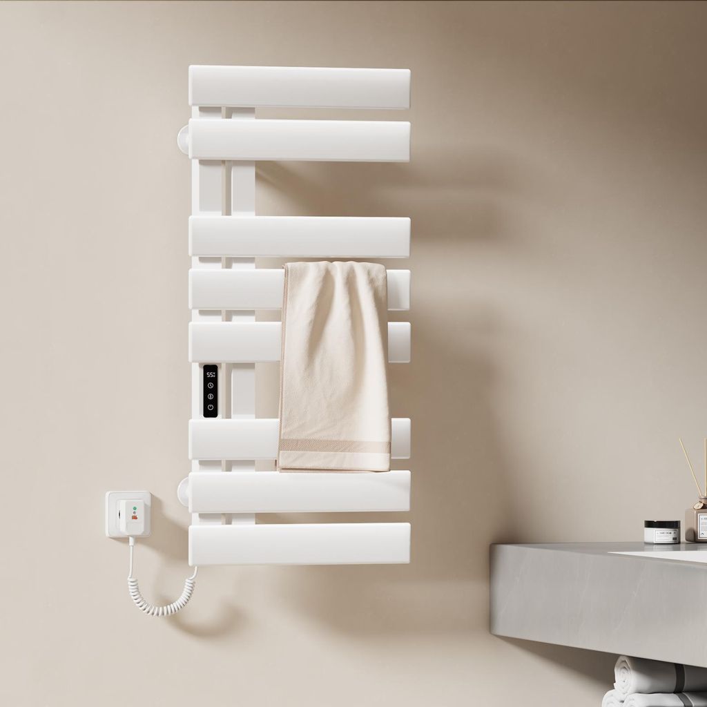 A white electric towel warmer mounted on a light beige wall in a bathroom setting.