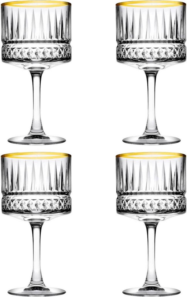 Four clear champagne glasses with gold rims are arranged in a two-by-two grid against a white background.
