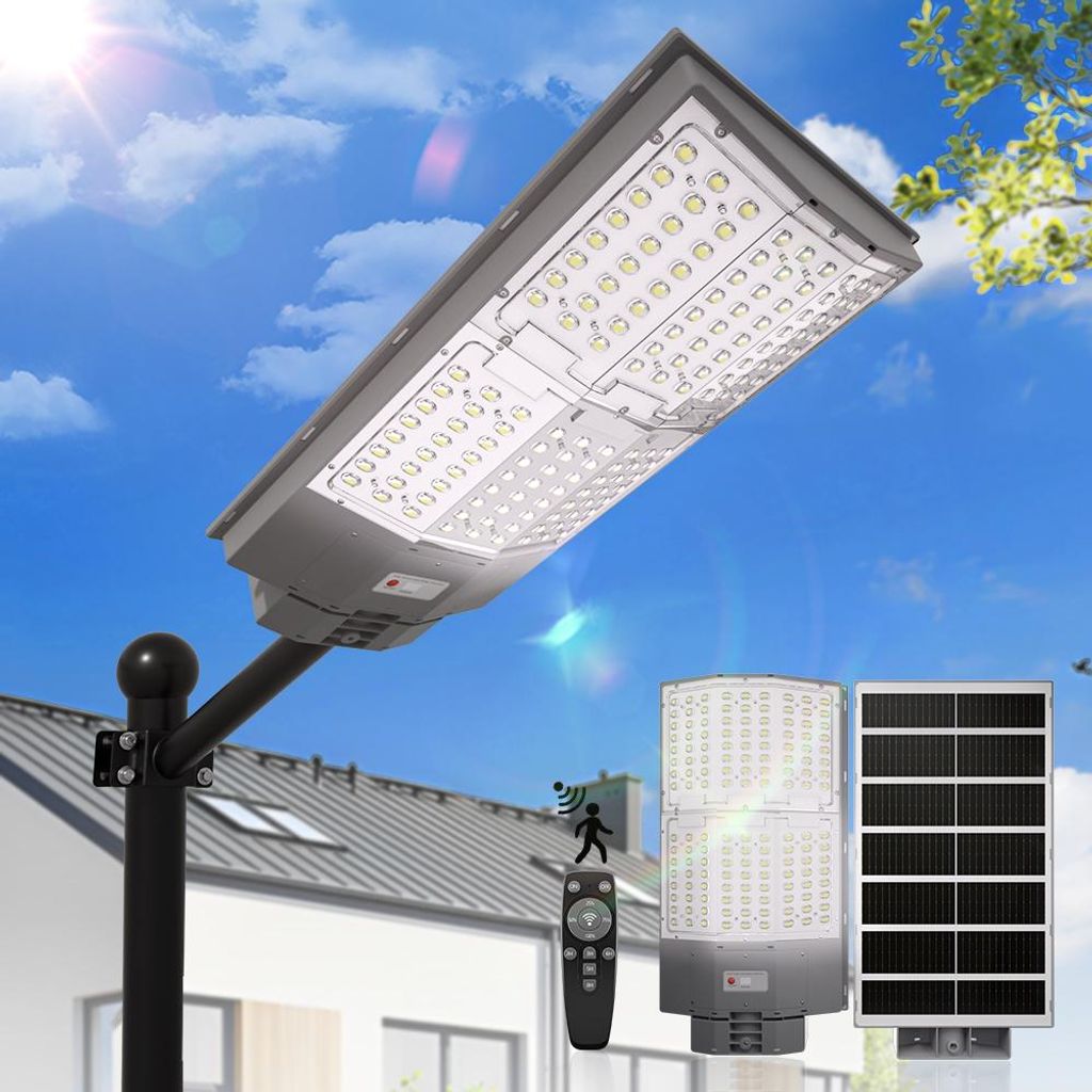 A solar-powered street light with a remote control and solar panel, set against a backdrop of a house and sky.