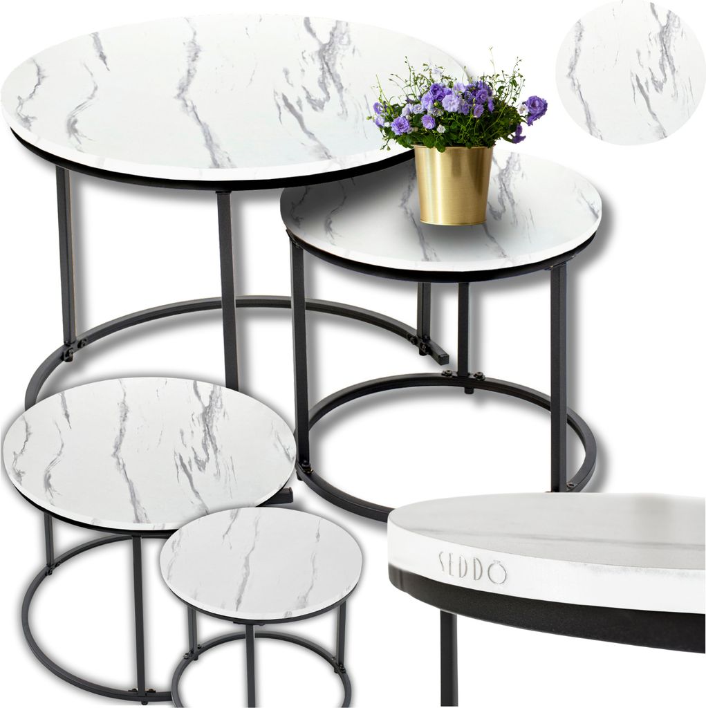 A set of nesting coffee tables with a marble-like pattern and gold accents, along with a small vase of flowers.