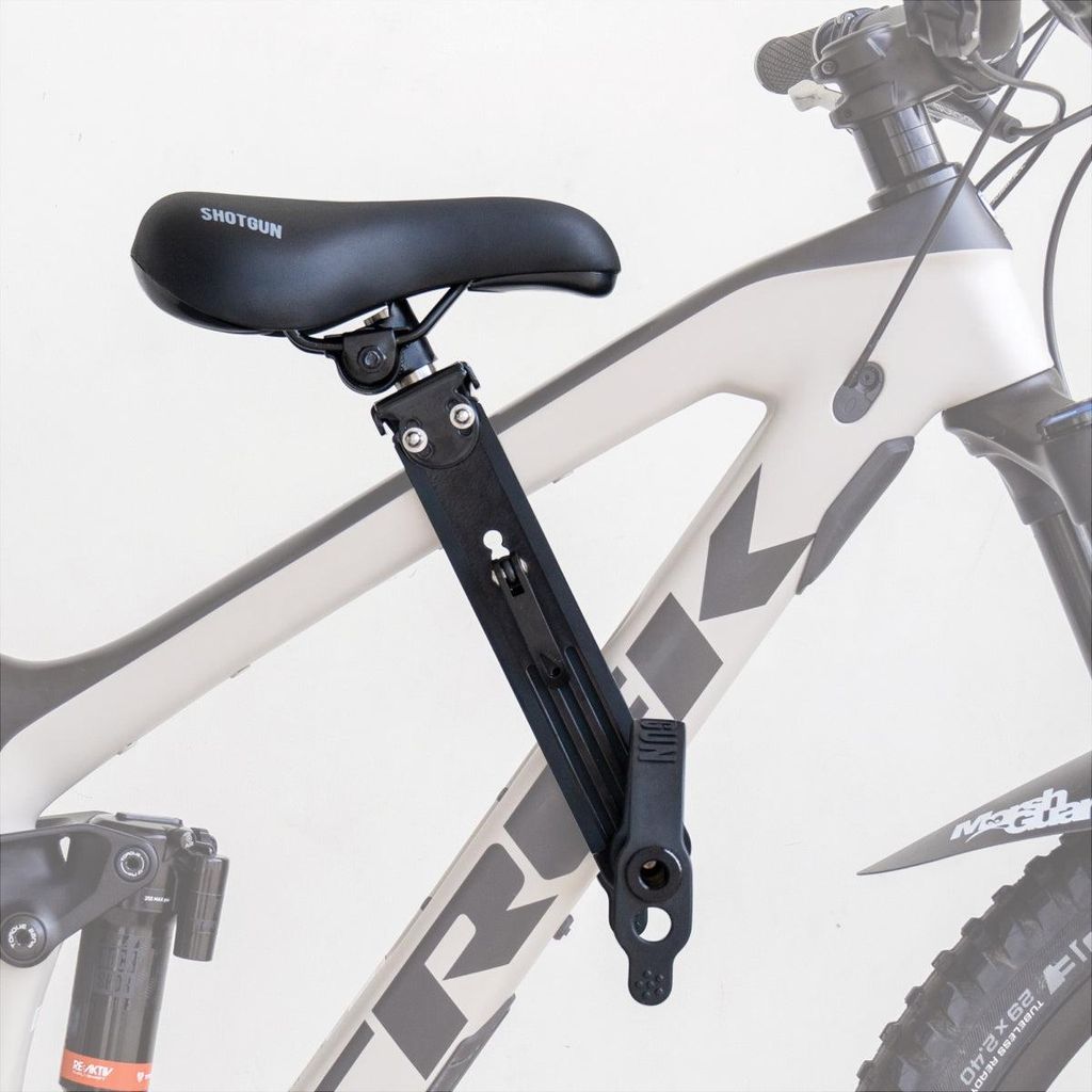 A child's bike seat attached to the frame of a mountain bike.