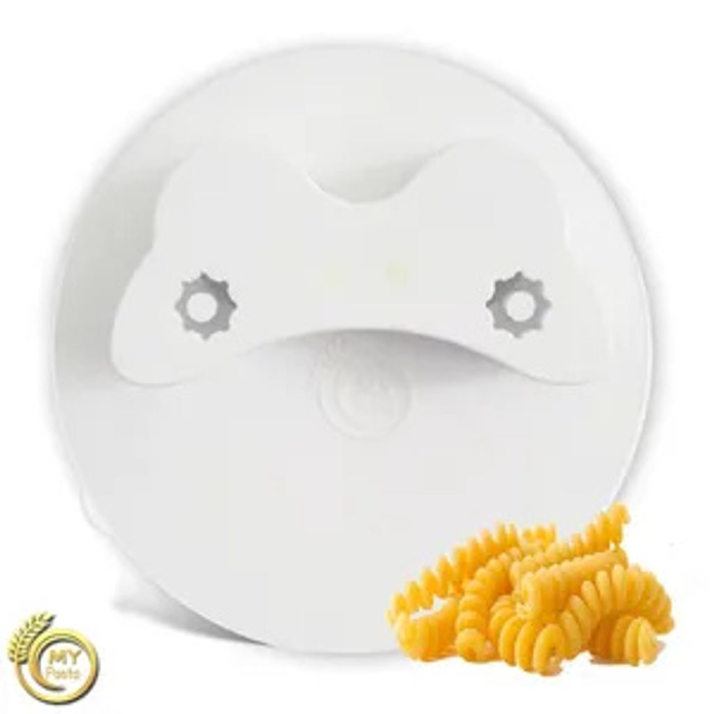 A white pasta maker attachment with a few fusilli pasta shapes in front of it.