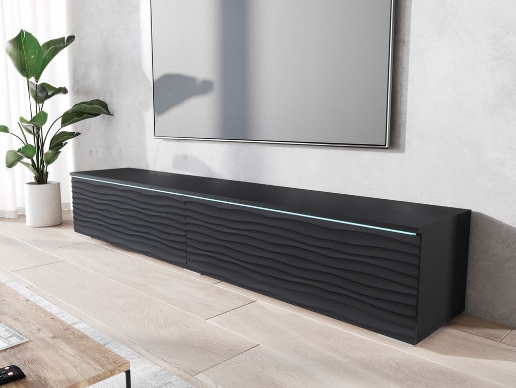 A modern living room with a black TV stand and a large TV mounted on the wall.