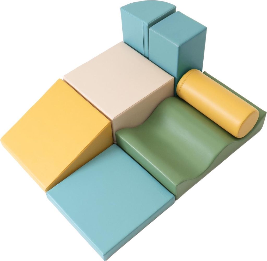 A collection of soft foam building blocks in pastel colors arranged in a playful, abstract formation.