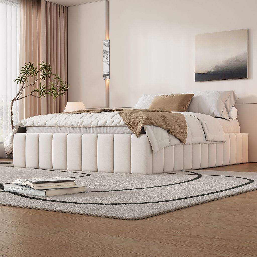A modern bedroom with a beige upholstered bed as the focal point.