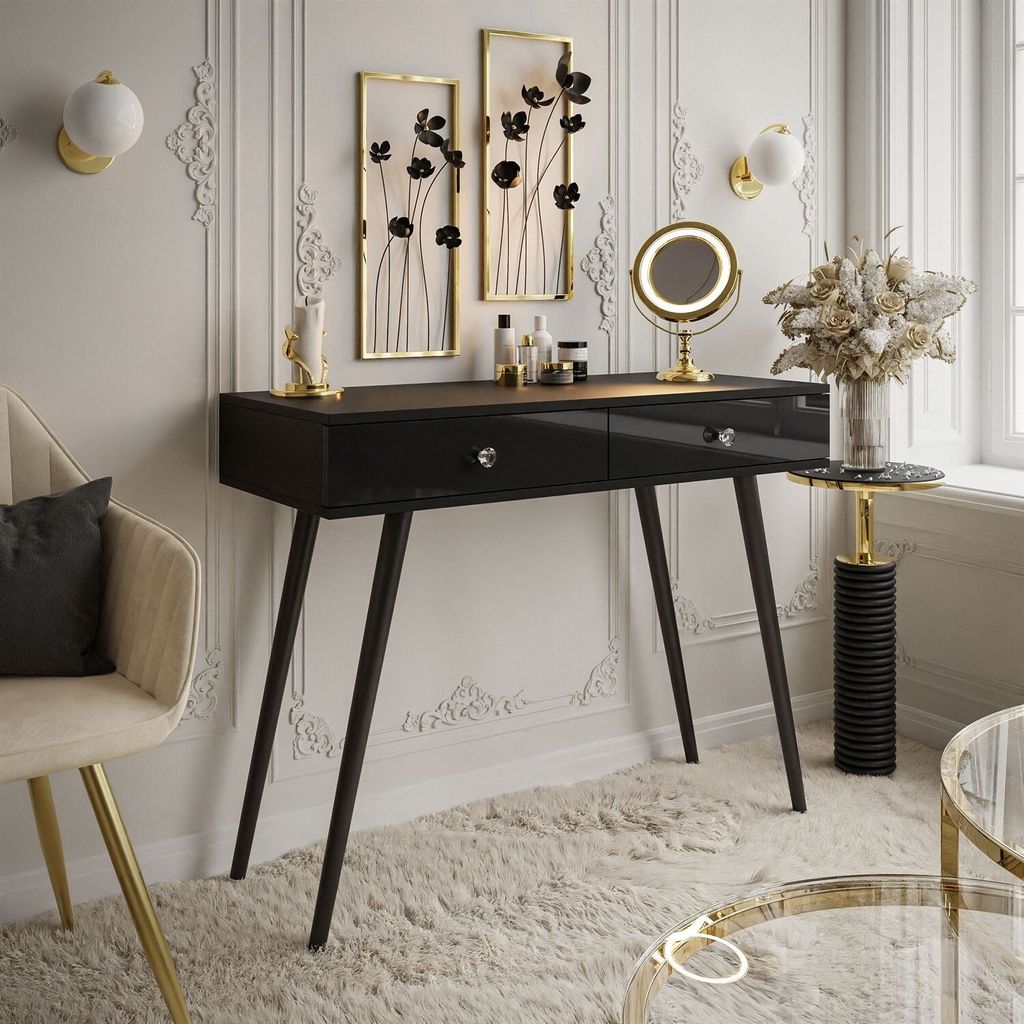 A modern vanity table setup with decorative elements and a chair.