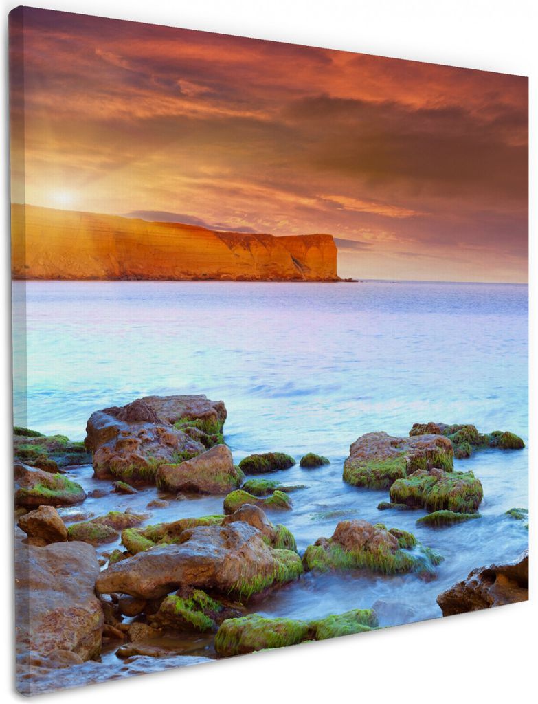 Wallario Premium Leinwandbild Sonnenaufgang am Meer mit Landzunge und Felsen im Wasser in Größe 50 x 50 cm