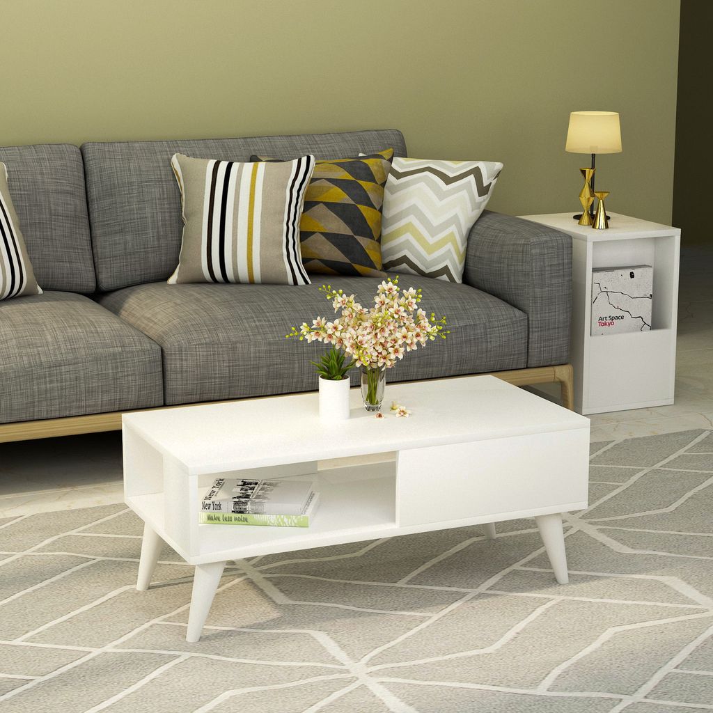 A living room scene with a couch, coffee table, and side table.