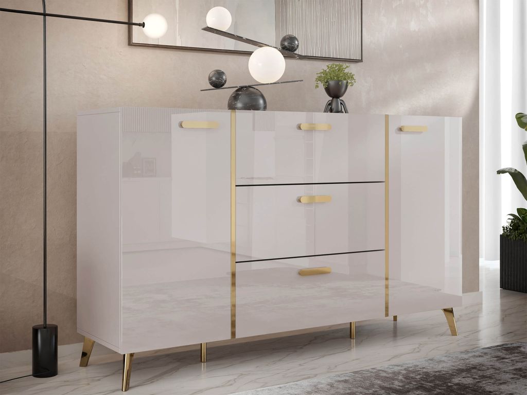 A modern, high-gloss white sideboard with gold accents, set in a well-lit room with a textured wall and marble-effect flooring.