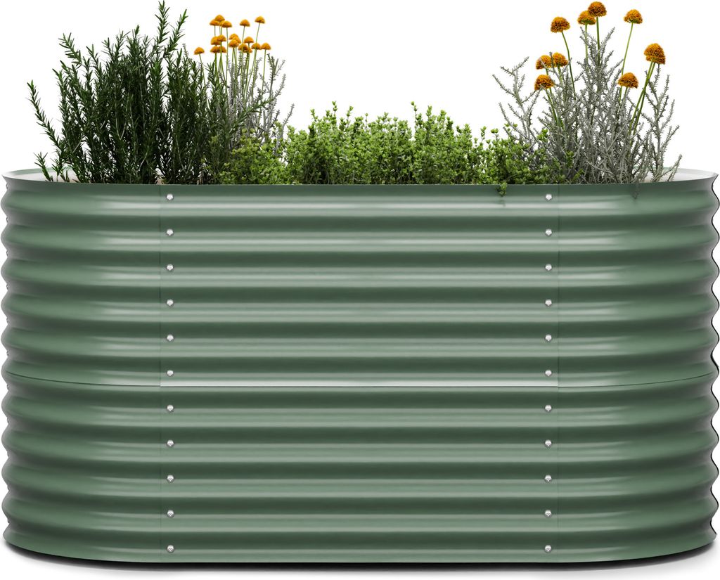 A green corrugated metal raised garden bed filled with various plants and herbs, set against a white background.
