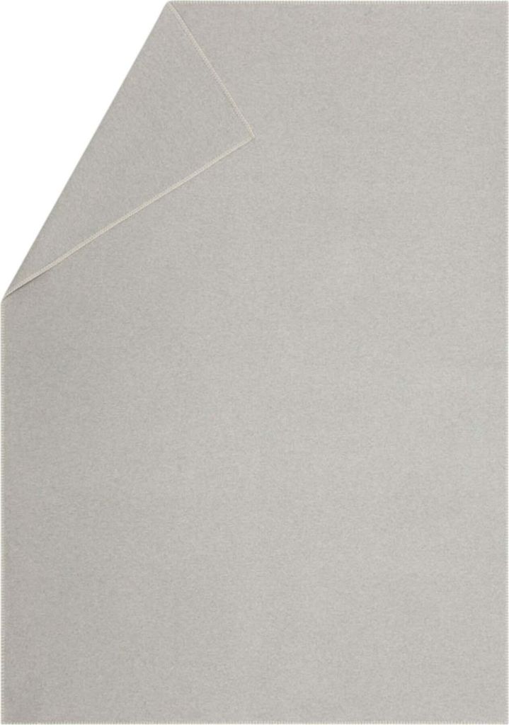 A light gray blanket folded in the corner.