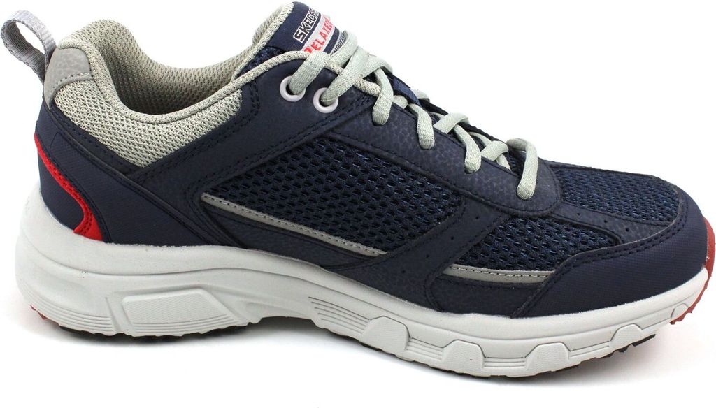 A side view of a single navy blue athletic shoe with gray laces and accents.