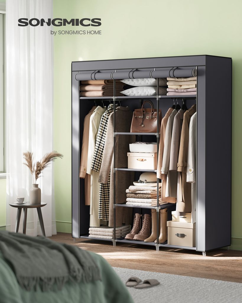 A portable wardrobe filled with clothing and accessories, displayed in a bedroom setting near a window.