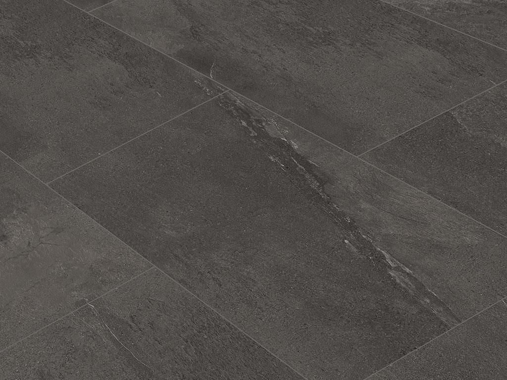 A close-up view of dark slate-look vinyl tiles laid diagonally.
