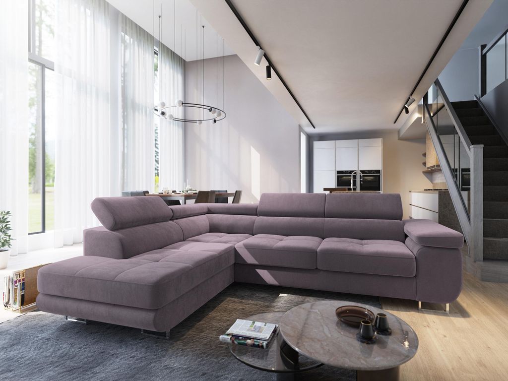 A modern living room with a sectional sofa, dining area, and stairs.