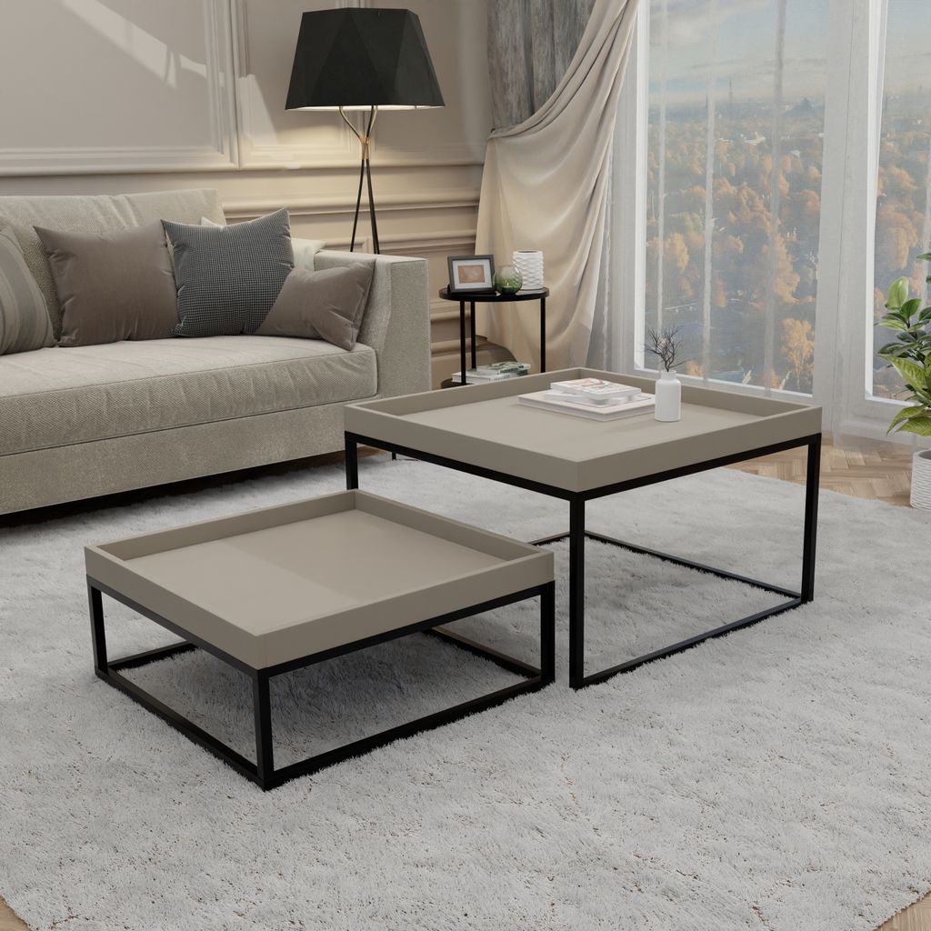 A living room scene with a sofa, coffee tables, and a window view.