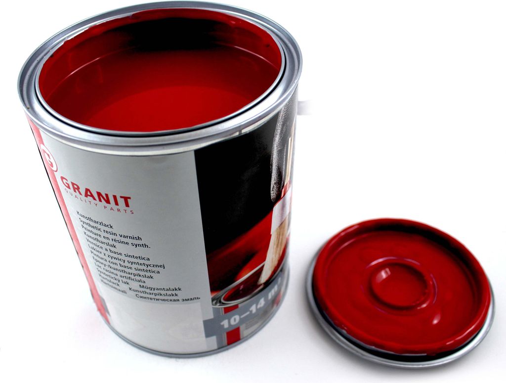 An open can of red paint with its lid next to it, on a white background.