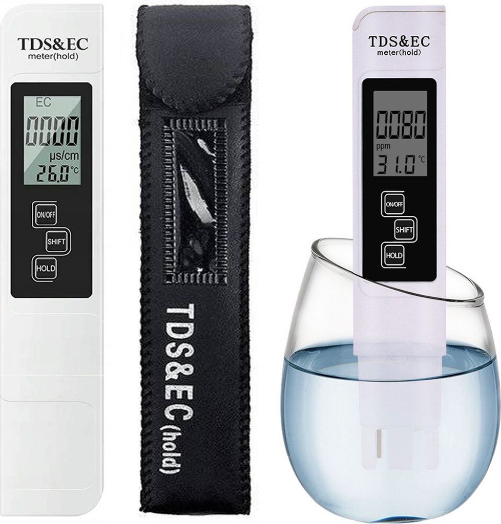 A digital TDS and EC meter with its protective sleeve and a glass of water.
