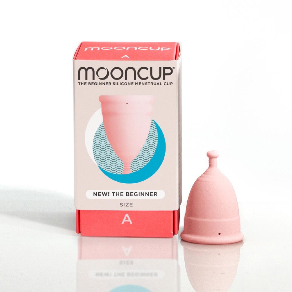 The mooncup beginner size A, a pink medical grade silicone menstrual cup with left the packaging box