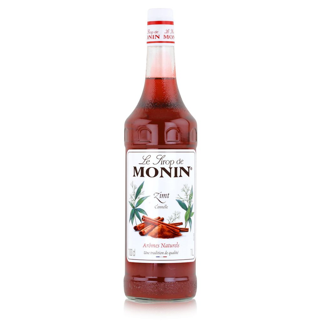 A bottle of Monin Cinnamon syrup against a white background.