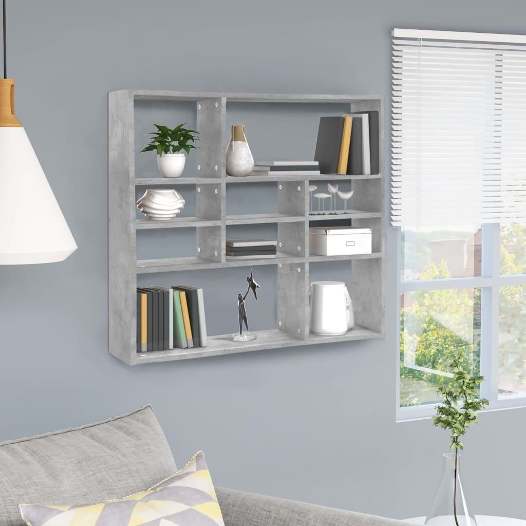 A wall-mounted shelf unit with various items displayed on it, next to a window with blinds.