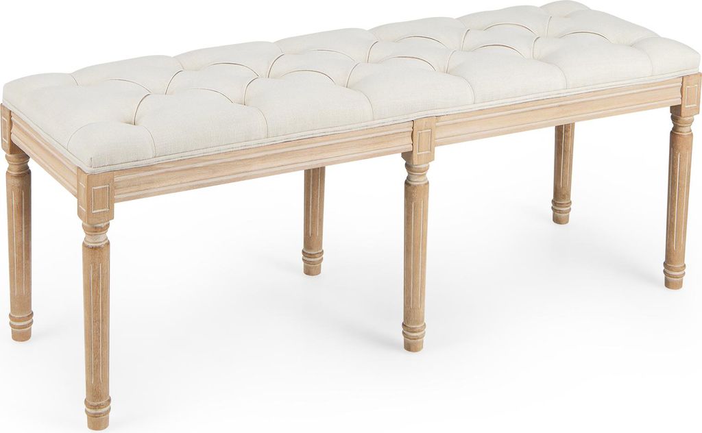A tufted upholstered bench with wooden legs, shown from a 3/4 angle on a white background.