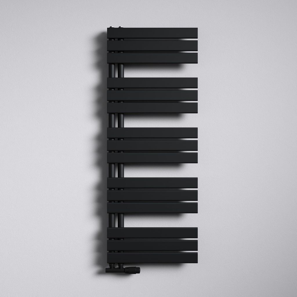 A black radiator mounted on a white wall.