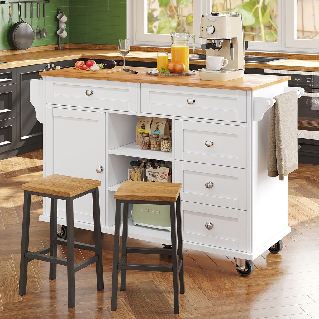 A kitchen island with stools and a coffee maker in a kitchen setting.
