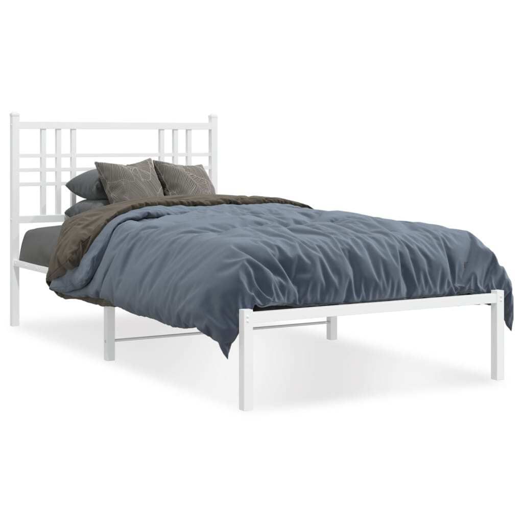 A white metal bed frame with a headboard, dressed with bedding, against a white background.