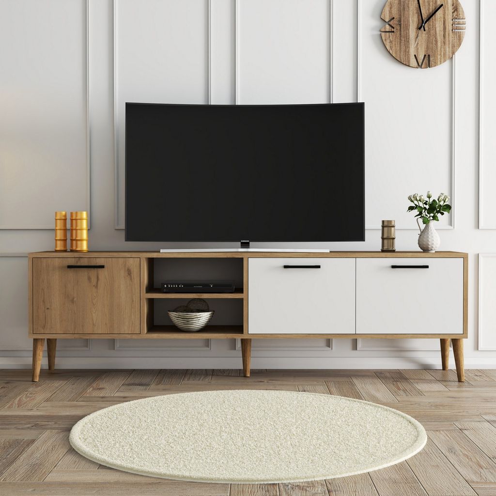 A modern TV stand with a TV on top, in a well-lit room.