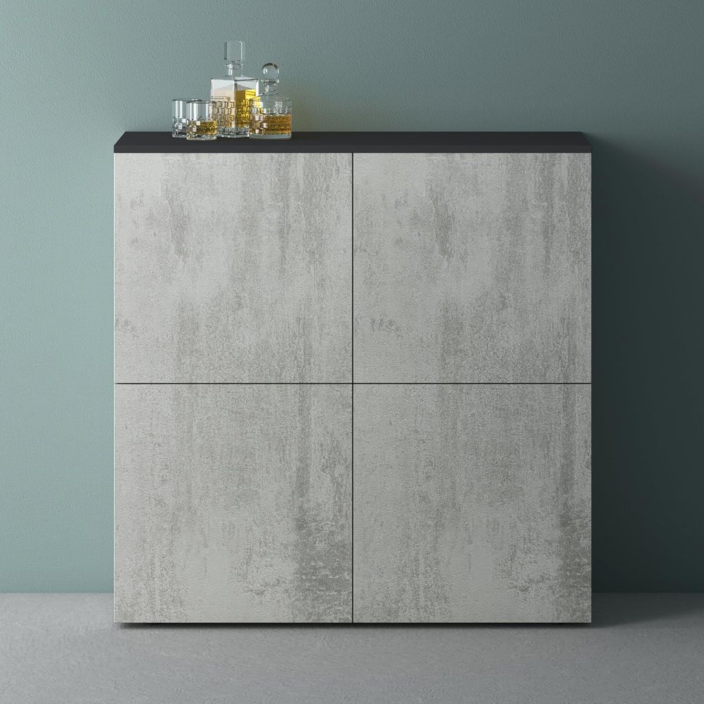 A modern sideboard with a concrete-look finish and a black top, set against a teal wall.