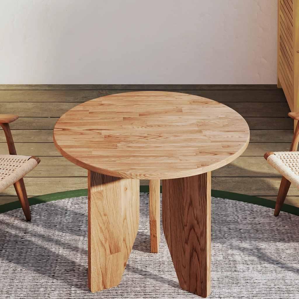 A round wooden table with two chairs in a room with wooden flooring and a rug.