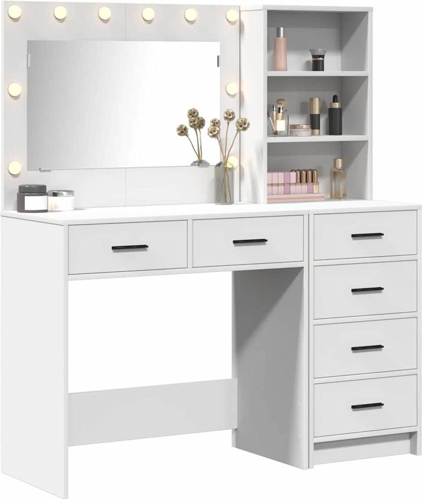 A white vanity table with a mirror and shelves, displaying various cosmetic items and decorative elements.