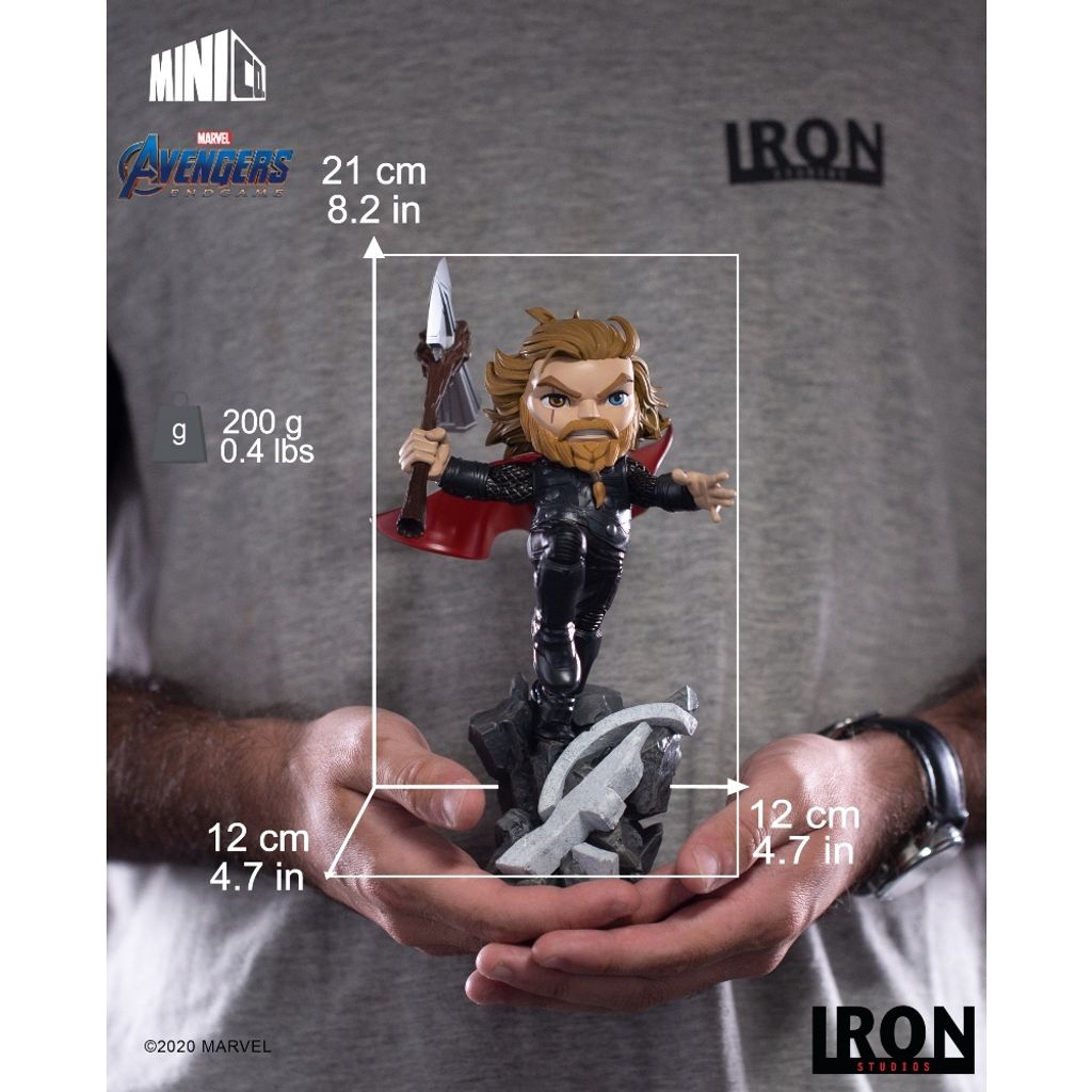 A person is holding a Thor figurine, with dimensions and branding information overlaid on the image.