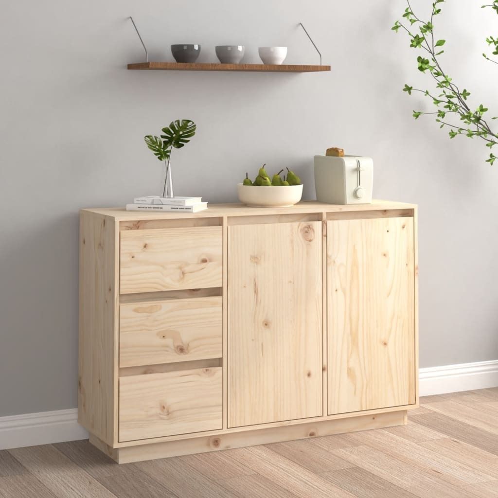 A wooden sideboard with drawers and doors, decorated with a vase of leaves, a bowl of pears, and a toaster.