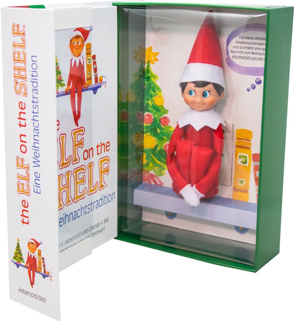 The Elf on the Shelf box set, showing the elf doll inside its packaging with a Christmas tree and books.