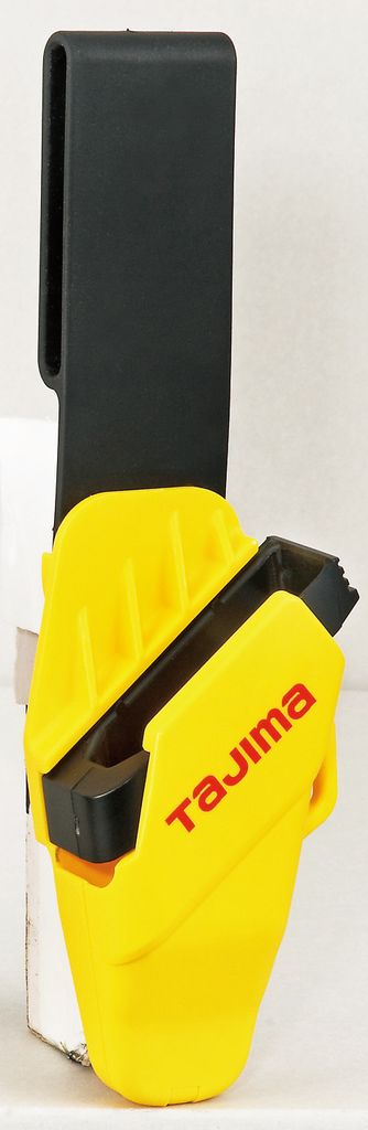 A yellow and black tool holster with the brand name 'Tajima' visible.