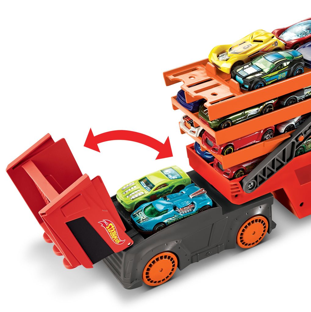 A toy truck with multiple toy cars loaded onto it, with some cars being released from the truck.