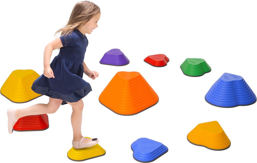 A young girl is playing on a set of colorful stepping stones.