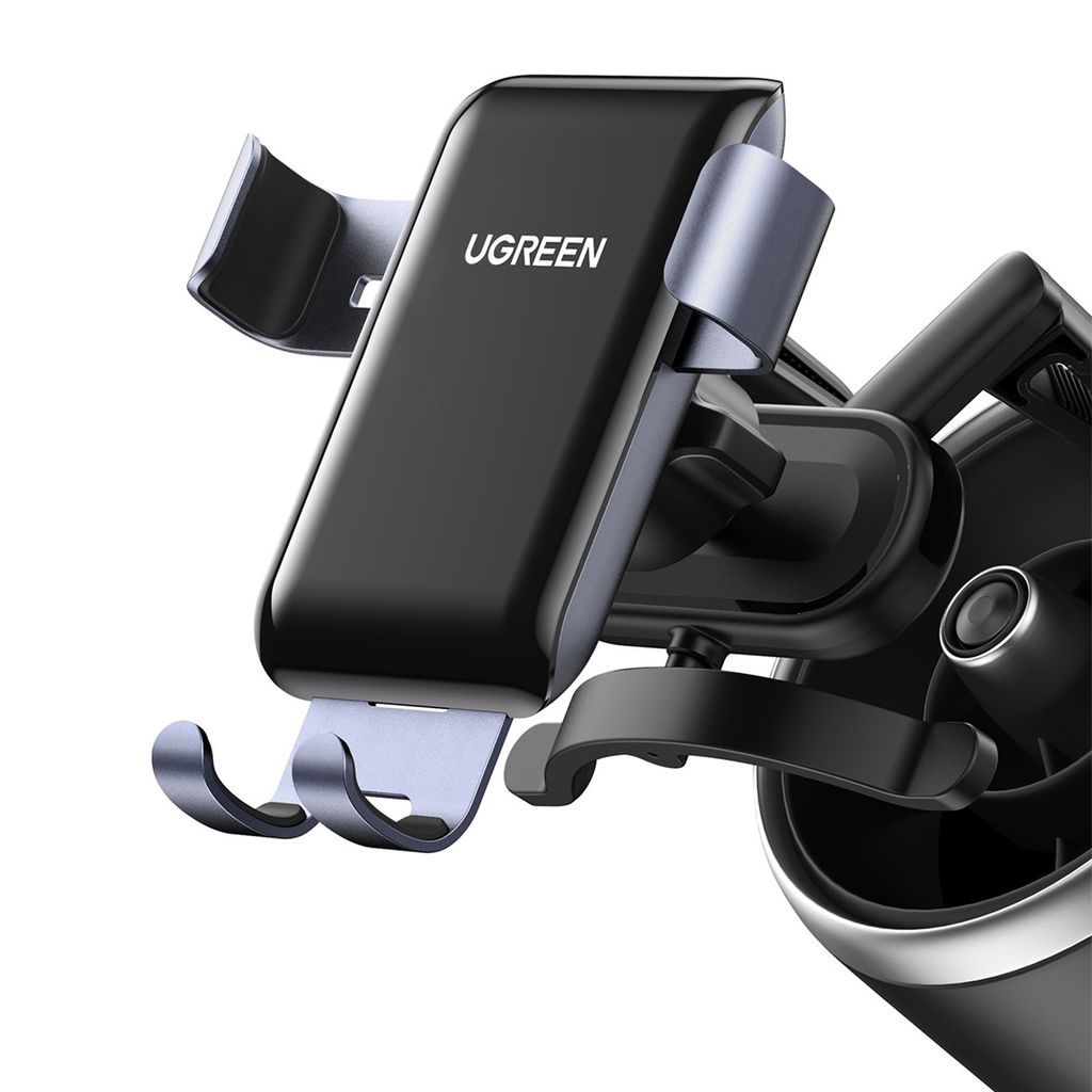 A close-up shot of a black and gray UGREEN gravity phone holder mounted on a car's air vent.