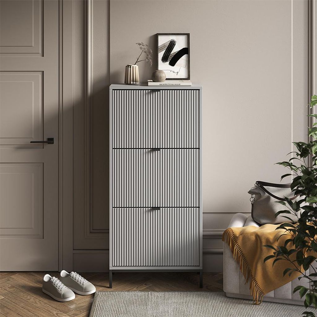 A hallway or entryway scene with a shoe cabinet, door, and seating.