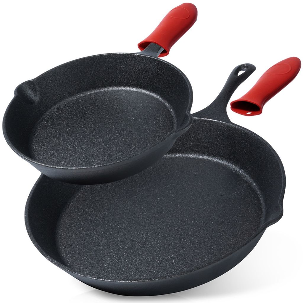 Two cast iron pans with red silicone handle covers are displayed against a white background.