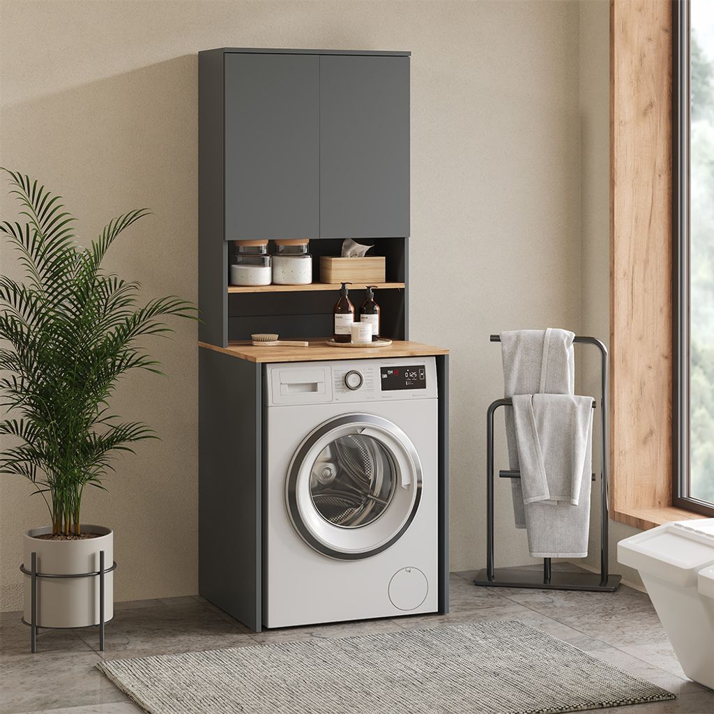 A laundry room setup with a washing machine and storage cabinets.
